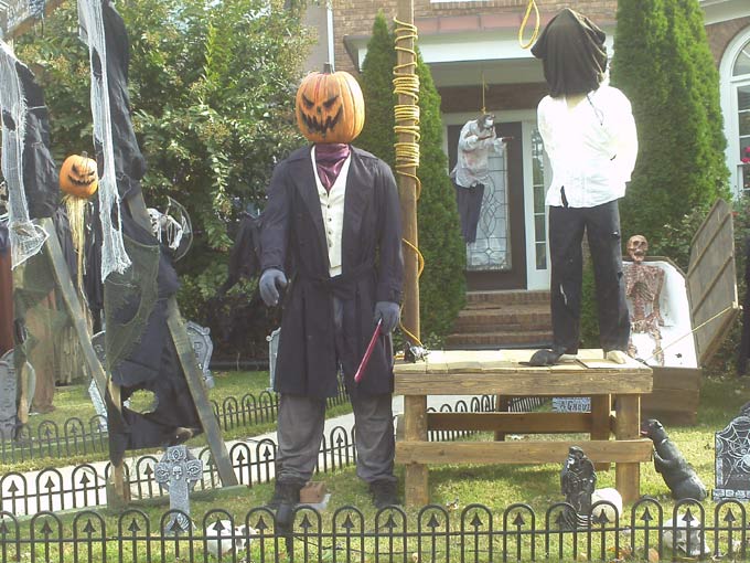 Day View of Gallows, Executioner, Mummy in Coffin with Scarecrow in Background